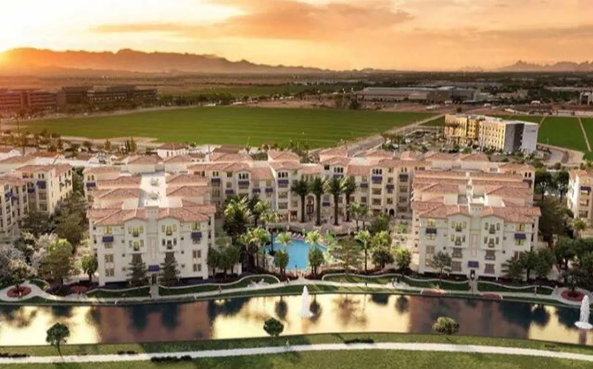 A tranquil pool area surrounded by palm trees, a fountain, and resort buildings, offering serene views perfect for relaxing after a day on the course. The image evokes luxury and a sense of escape.